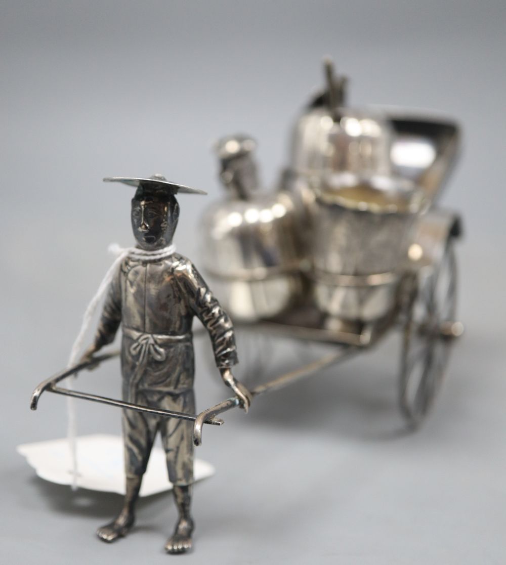 An early 20th century Chinese Export white metal cruet stand, modelled as a rickshaw, maker KC, length 21.5cm.
